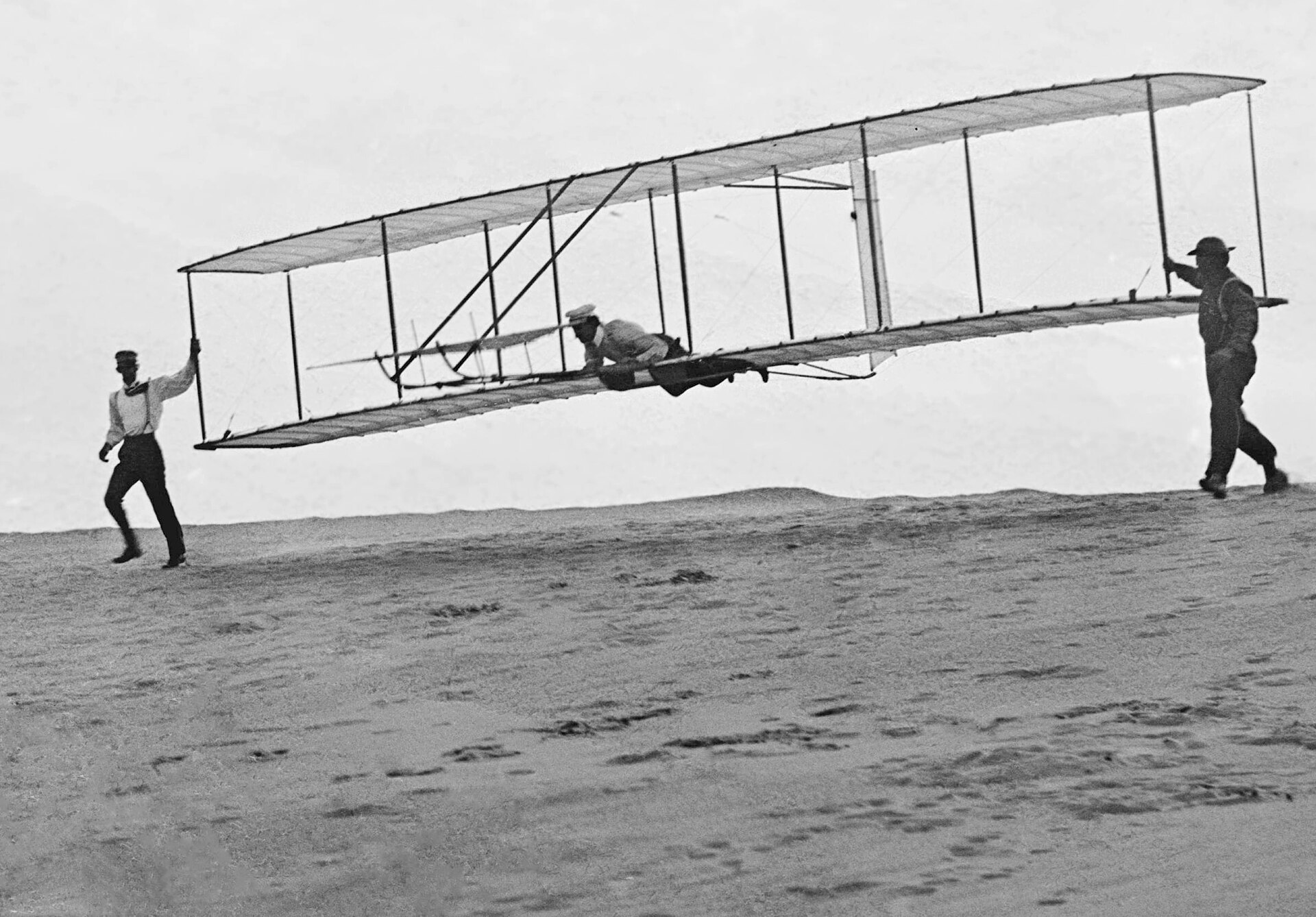 The Wright brothers testing their glider on the dunes at Kitty Hawk, 1902