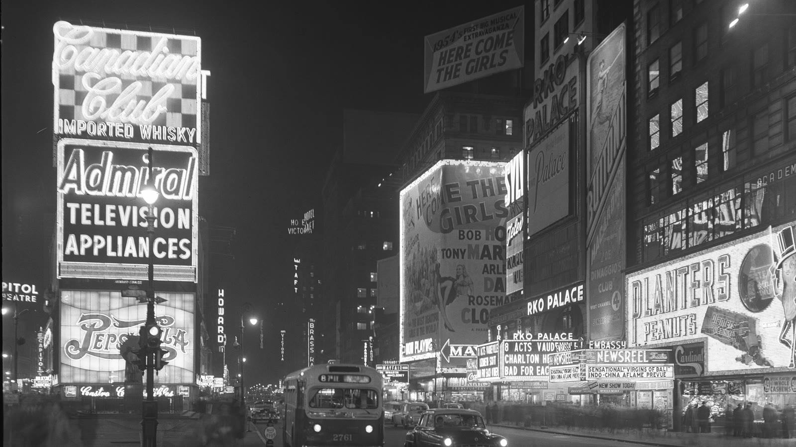 Times Square at night, lit up with neon advertising signs