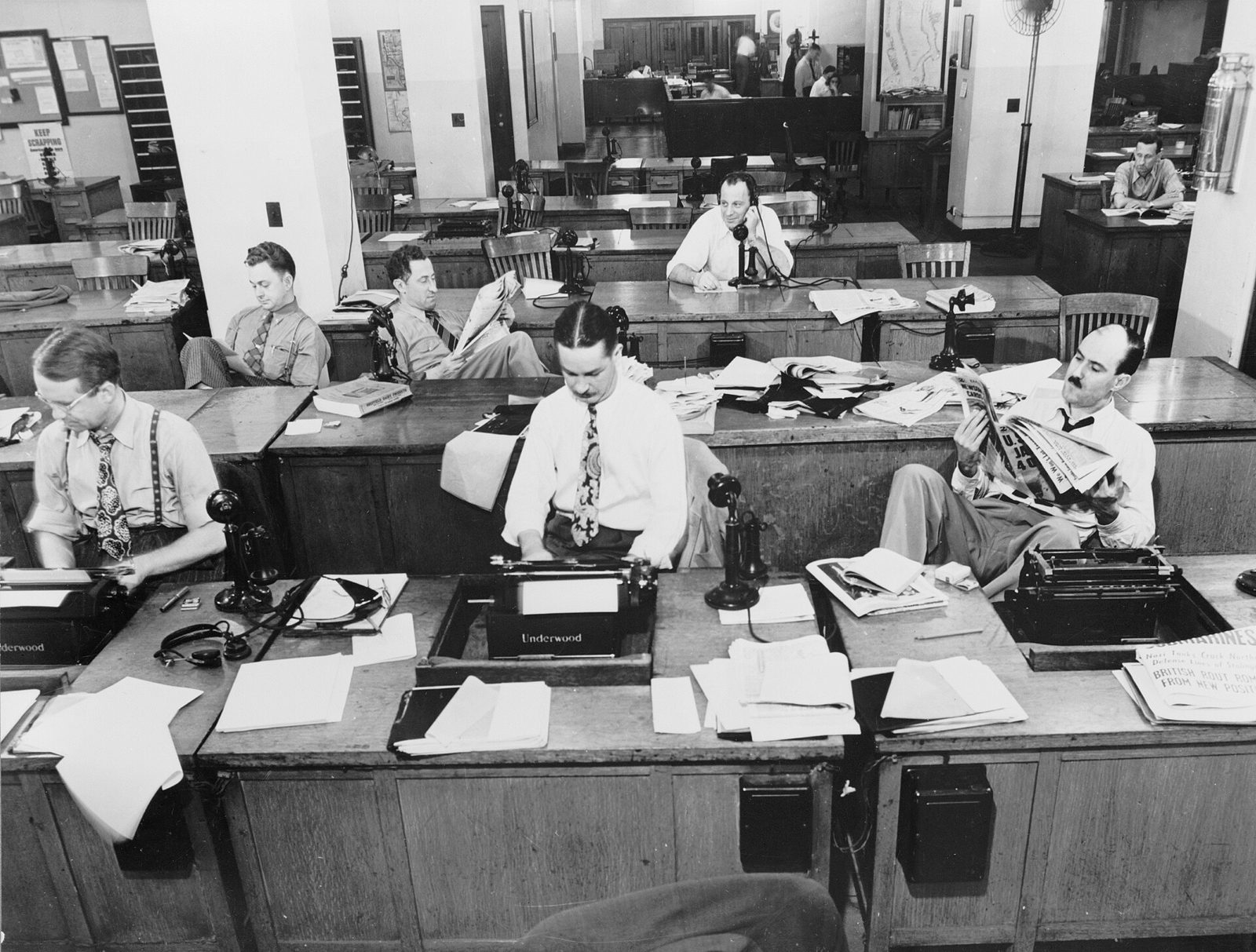A busy newsroom with editors at their desks, 1942